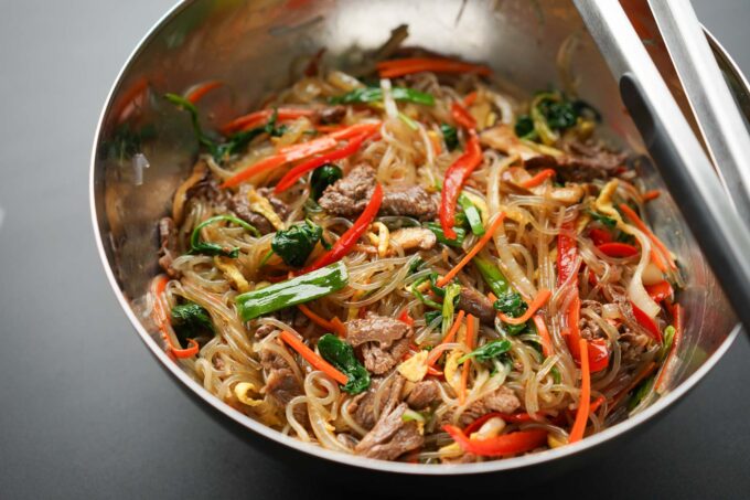 japchae in metal mixing bowl