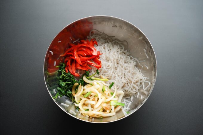 adding bell pepper to mixing bowl