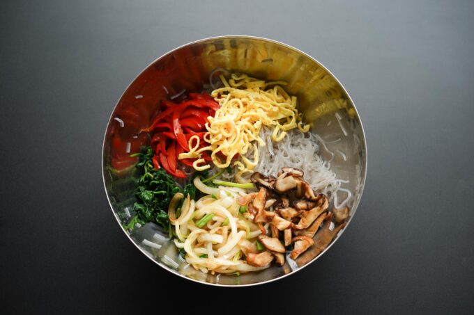 adding mushrooms to mixing bowl