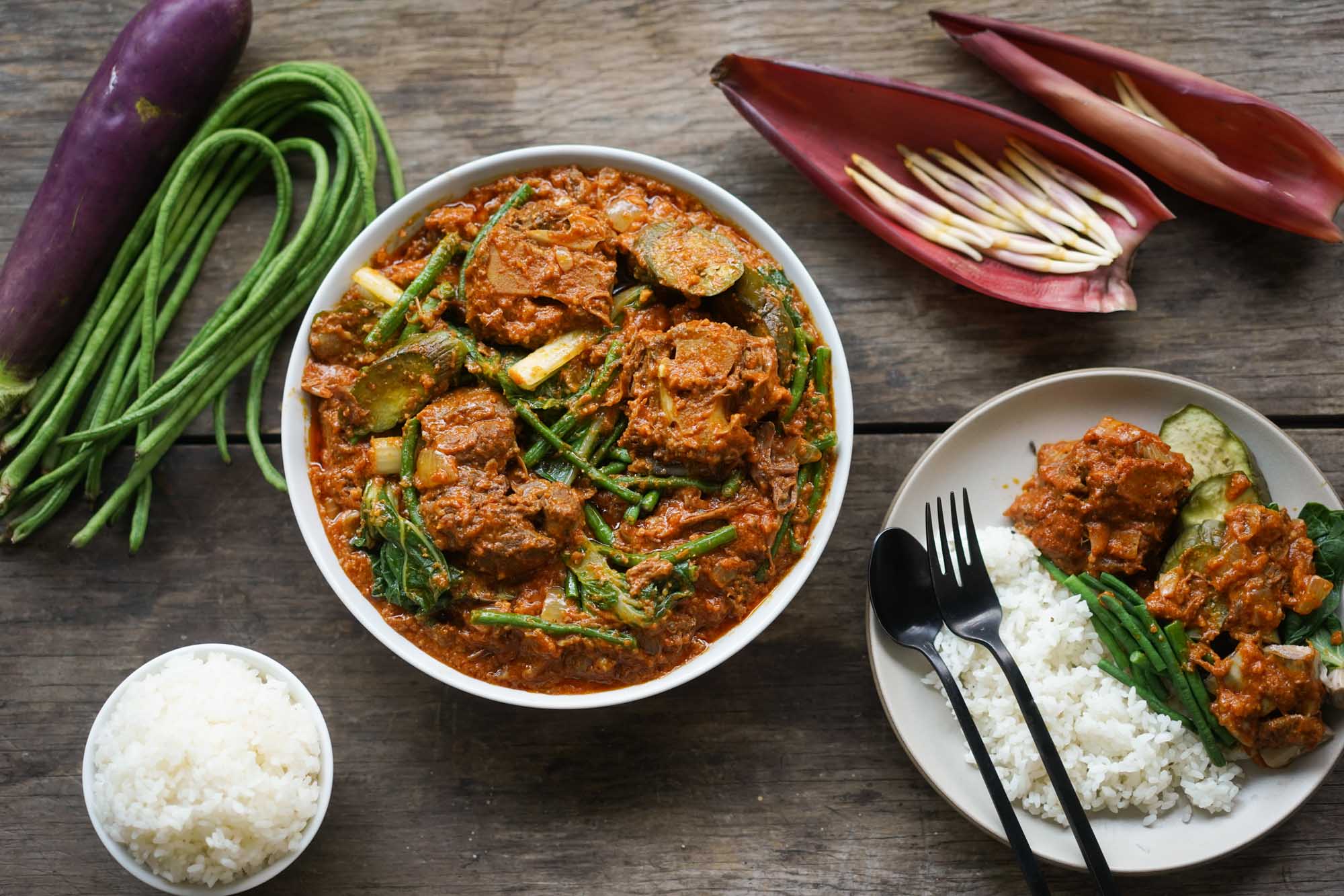 bowl of kare kare with rice plate