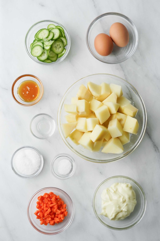 ingredients for potato salad in glass bowls