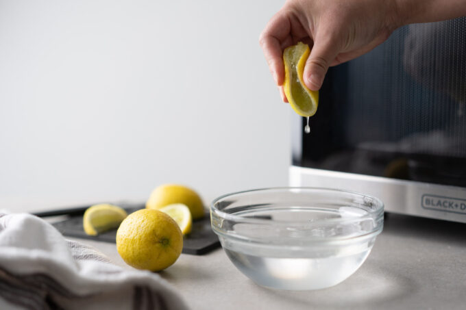 squeezing lemon juice into water bowl