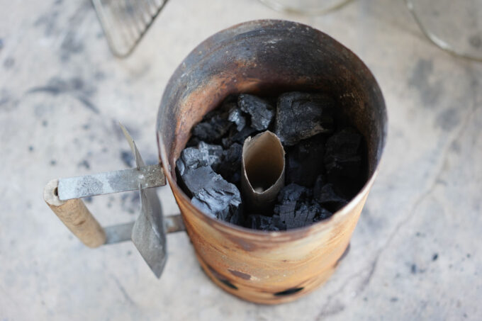 chimney starter with toilet paper roll and coals