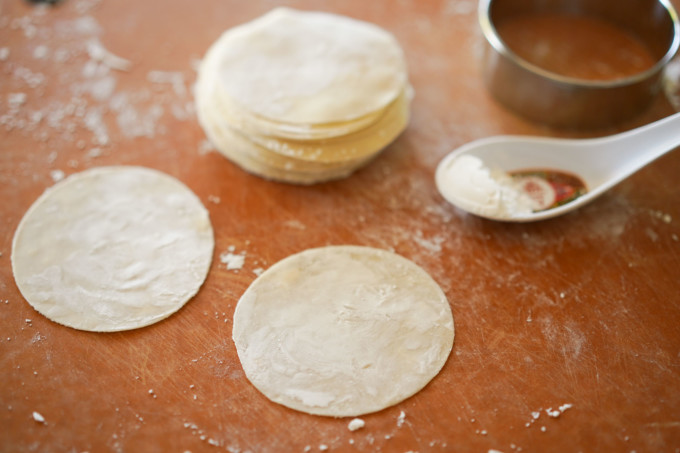 flouring homemade dumpling wrappers with cornstarch