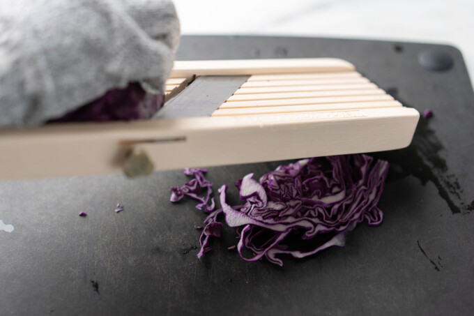 slicing red cabbage on a mandolin
