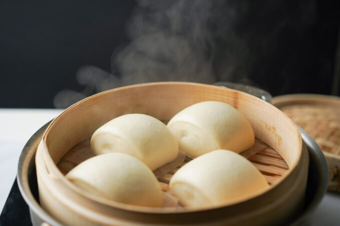 steamy mantou on bamboo steamer