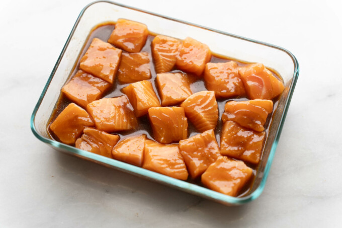 marinading salmon cubes in glass container