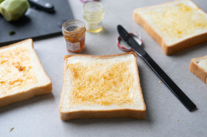 jam spread onto sliced bread