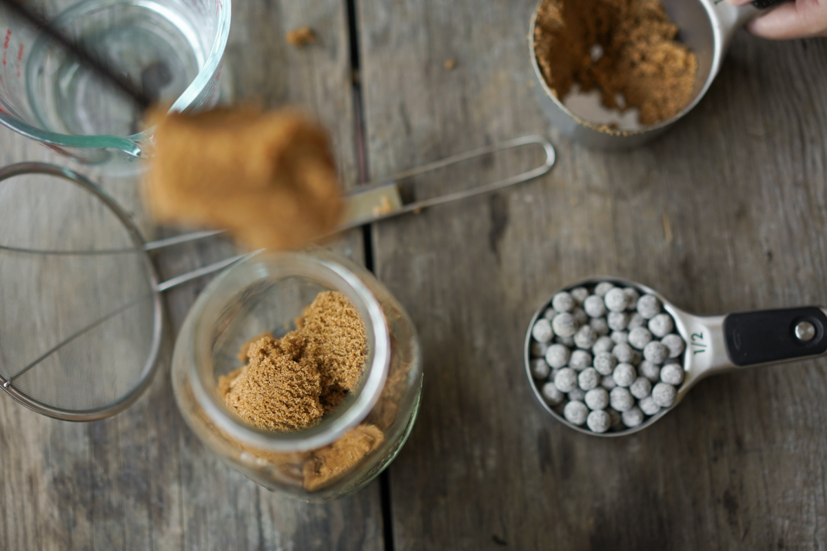 measuring out brown sugar for boba sweetening