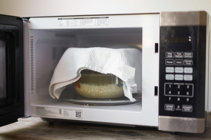 bowl of rice in microwave, covered with towel