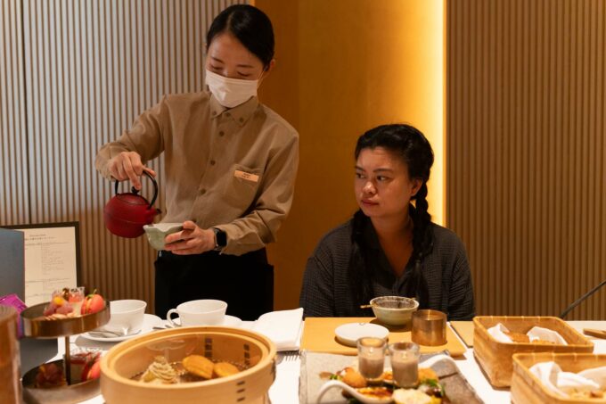 host serving tea in private tea service