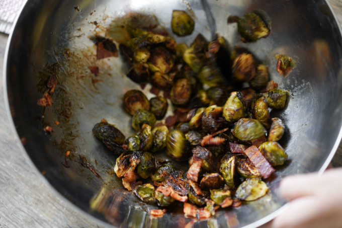 mixing glaze into brussels sprouts