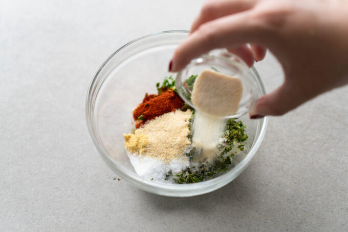 adding herbs and butter together