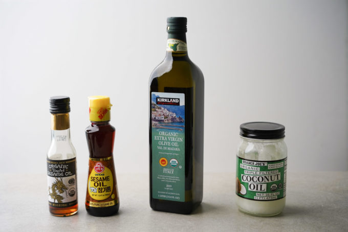 bottles of sesame oil, extra virgin olive oil, and coconut oil