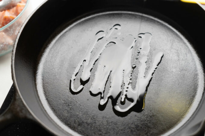 drizzling oil into cast iron pan
