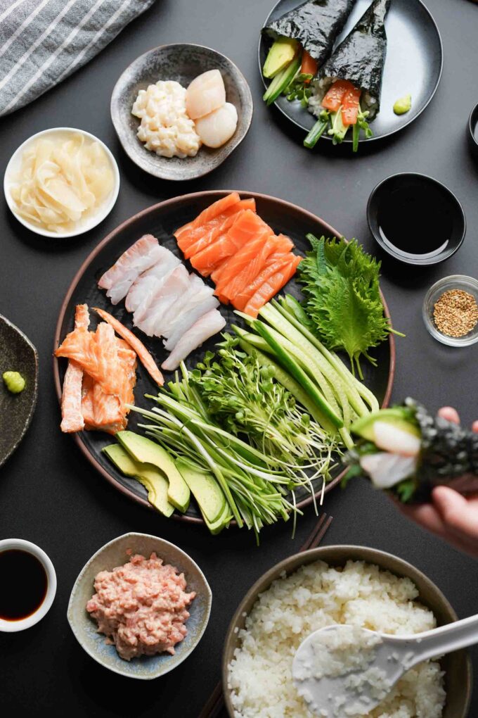 hand roll fish and veggies on a large plate