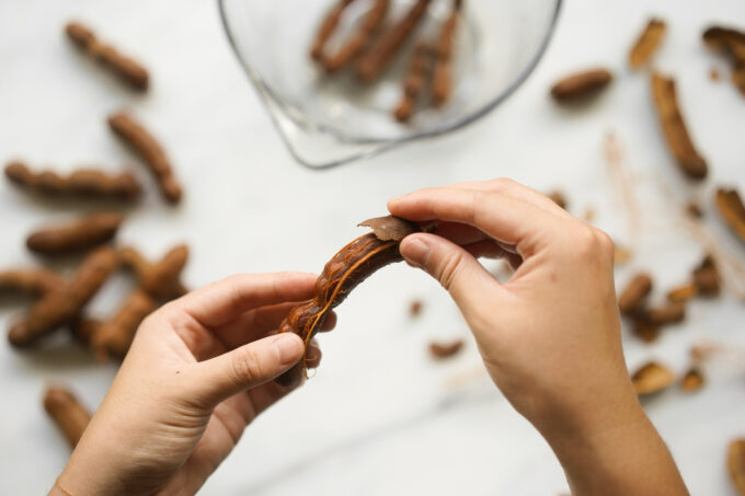 peeling tamarind shells by hand