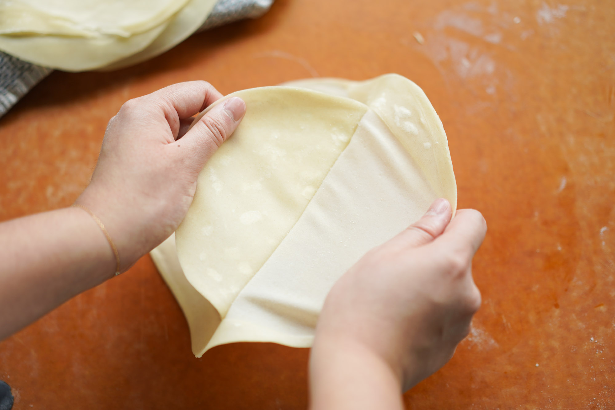 peeling apart cooked spring roll wrappers