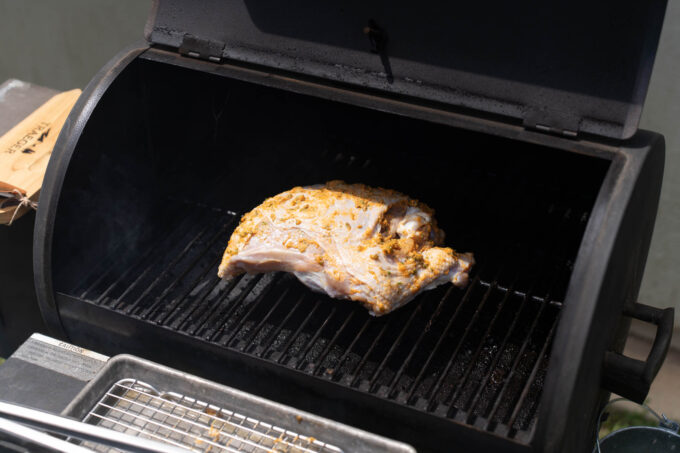 turkey breast placed on smoker grates