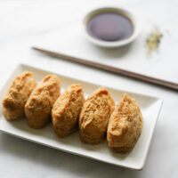 plate of plain inari sushi with soy sauce