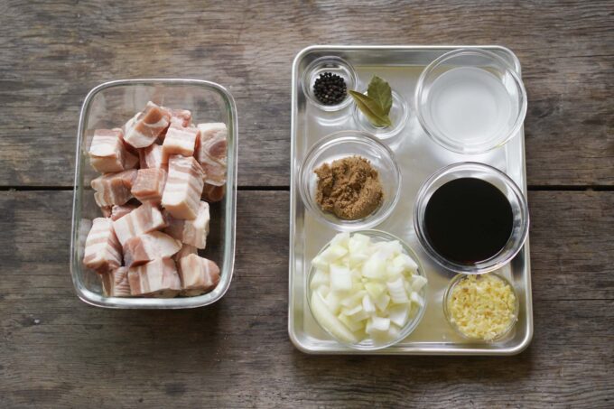 pork belly chunks next to tray of marinade