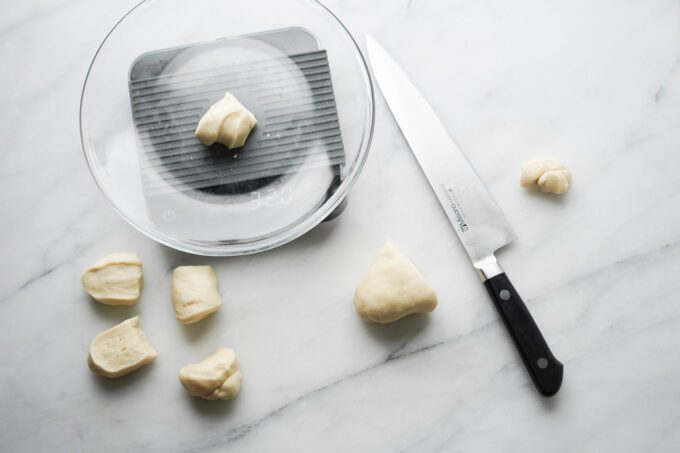 weighing out dough balls on scale