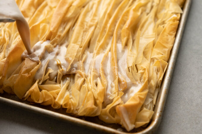 pouring custard onto crinkle cake