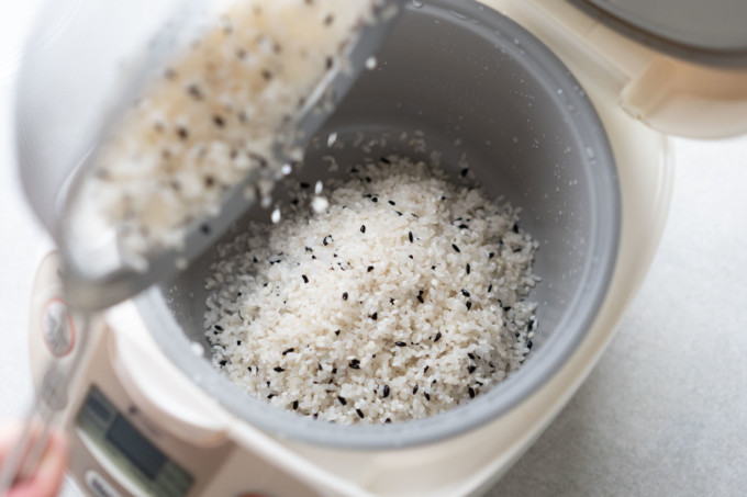 pouring rice into pot from strainer