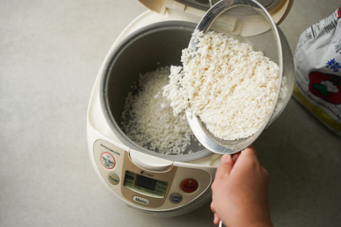 pouring rice into rice cooker