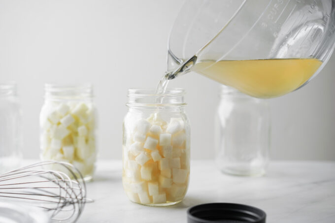 pouring pickling liquid onto daikon