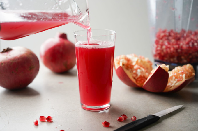 pouring a glass of pomegranate juice