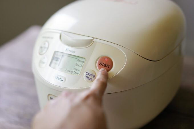 pressing start on a rice cooker