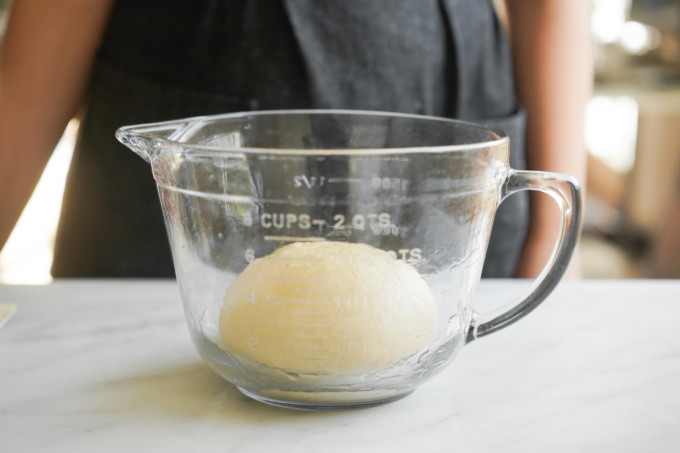 dough ball in glass container before rising