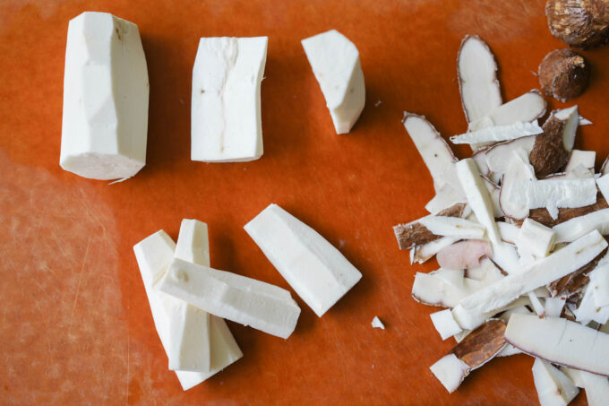 slicing cassava into sticks for shredding