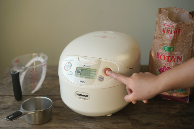 pressing start button on rice cooker