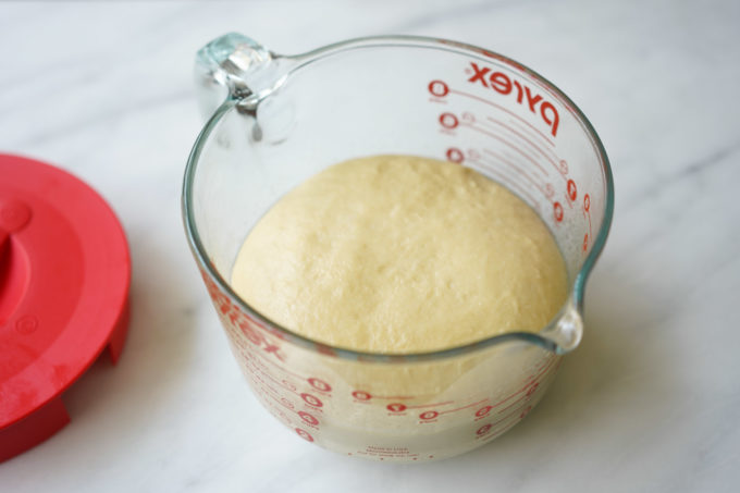 proofed dough in a glass container