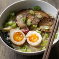 ramen eggs on a bed of ramen and chashu