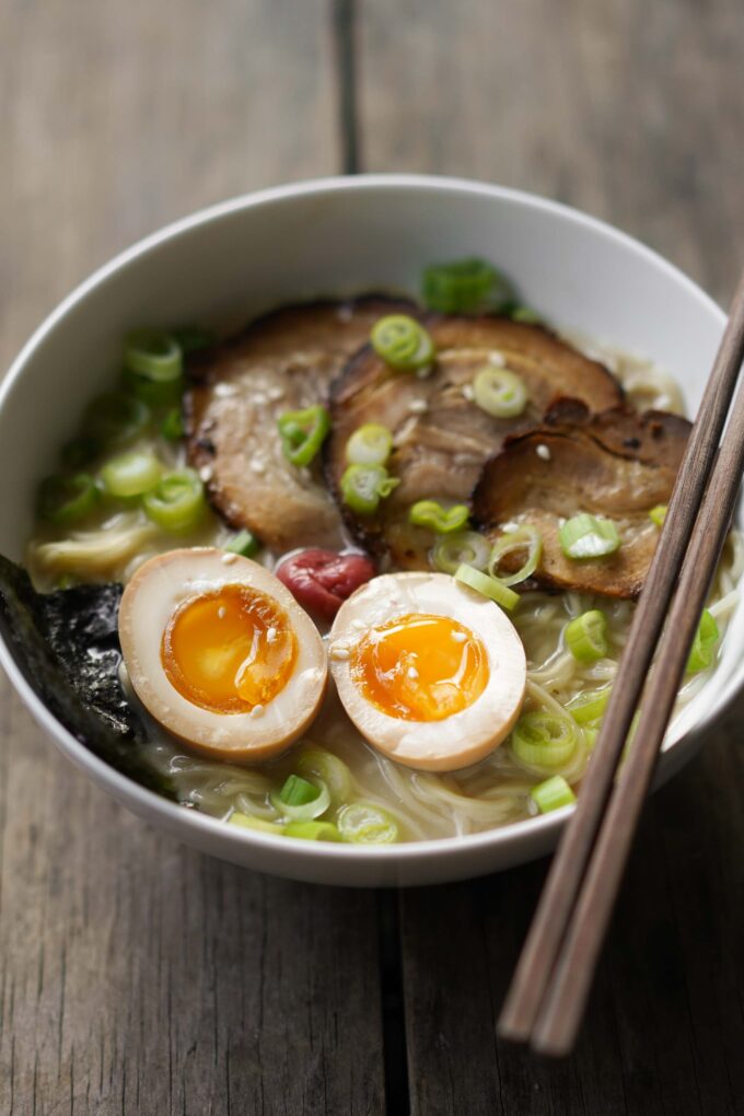 ramen eggs on a bed of ramen and chashu