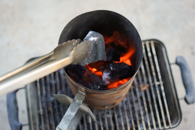holding charcoal with bbq tongs