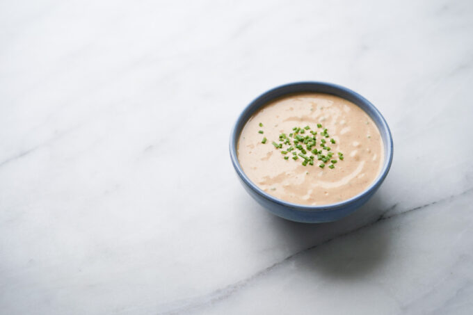 blue bowl with crab cake sauce