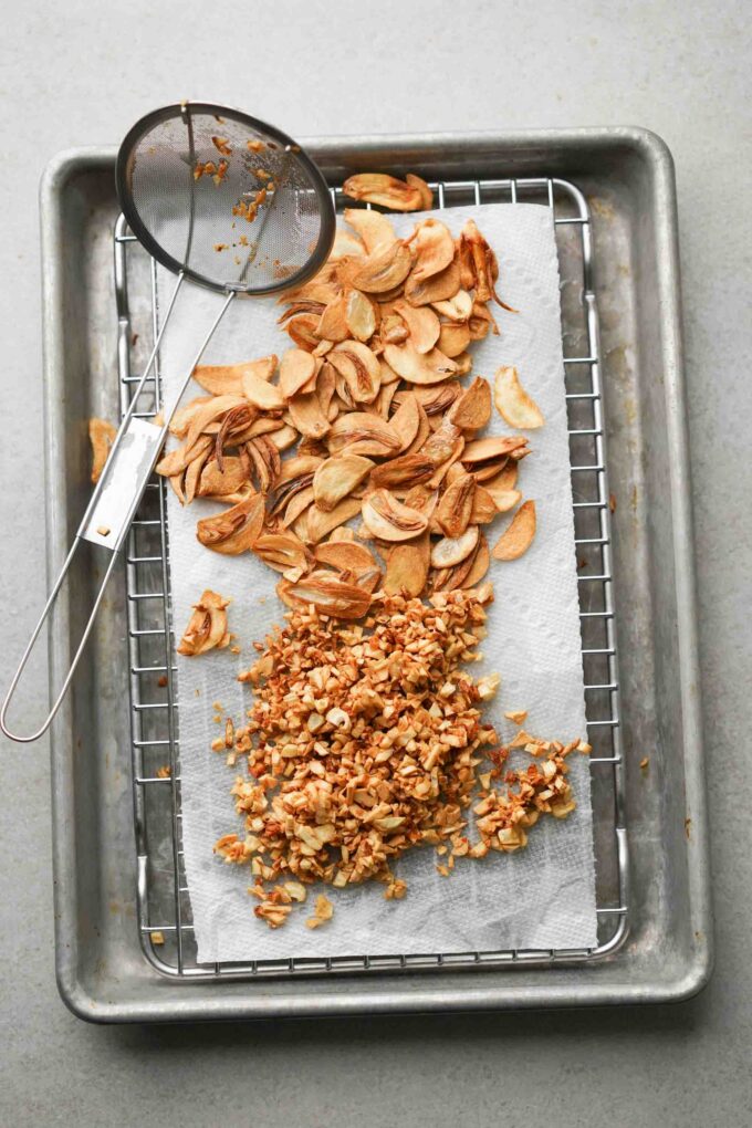 fried garlic cooling on paper towel