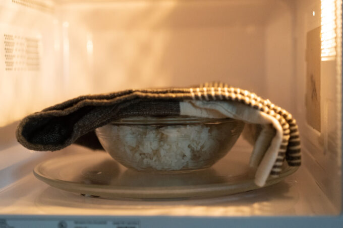 towel on top of rice bowl in microwave