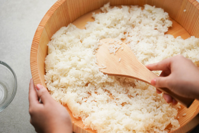 mixing rice grains with rice paddle