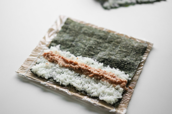 setup of rice, fish, and seaweed before rolling up