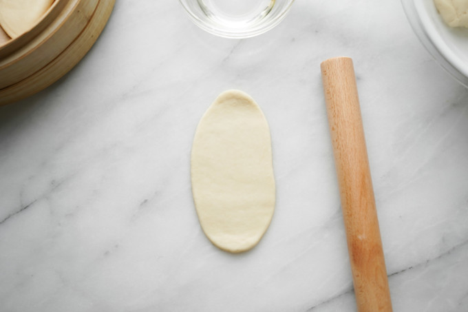 rolling out dough ball with rolling pin
