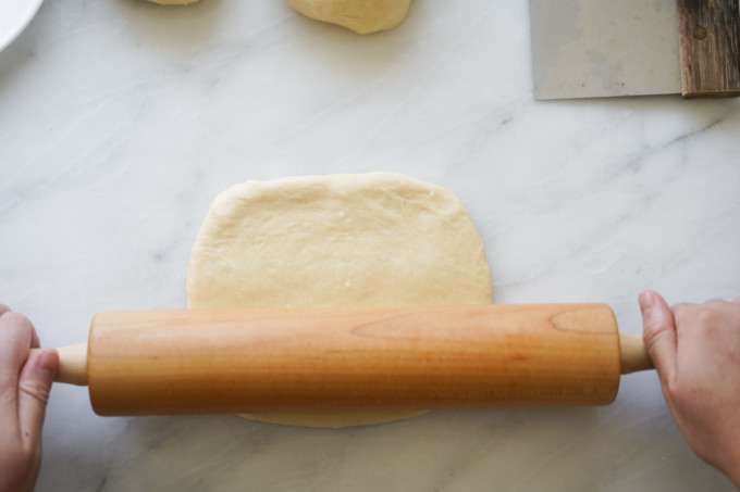 rolling dough into square with rolling pin