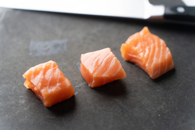 cubed salmon pieces on cutting board