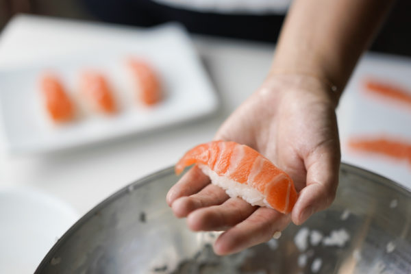 sushi rice formed into nigiri shape for salmon sushi