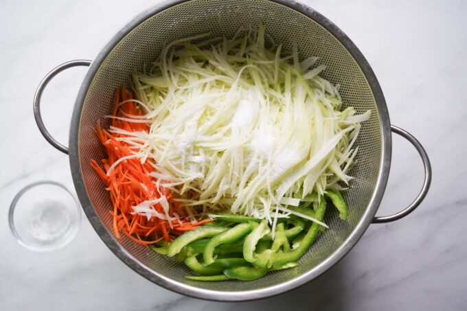 salted papaya and veggies in strainer