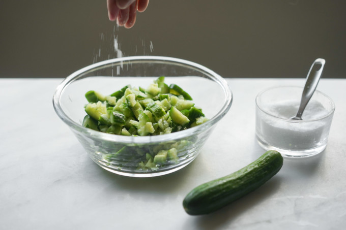 salting sliced cucumbers